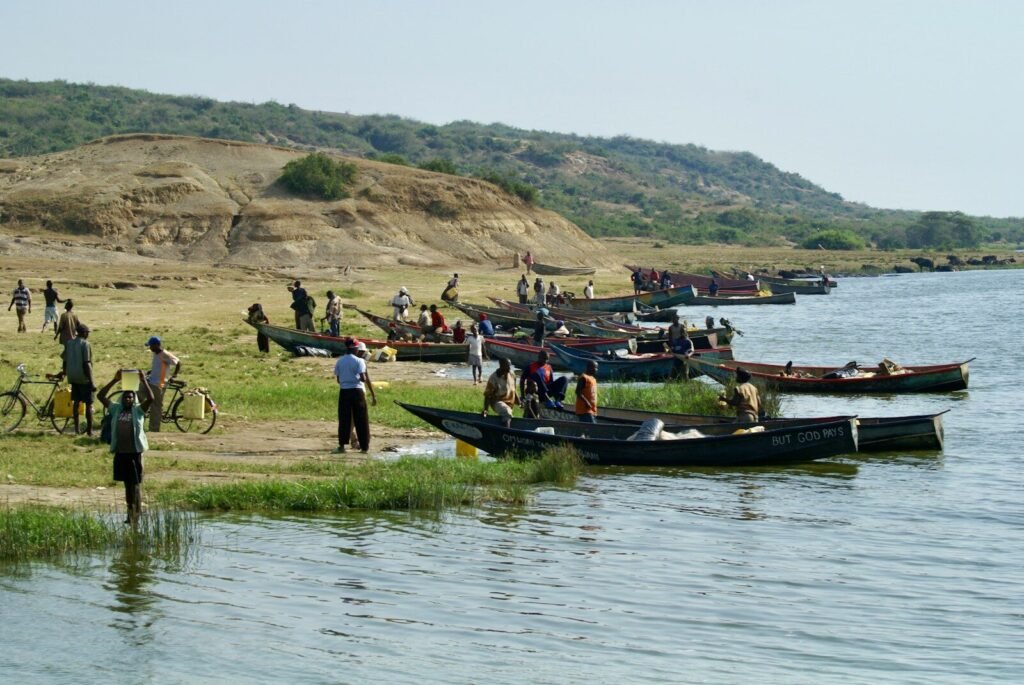 A group of people standing next to a body of water